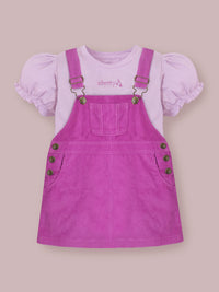 Brighten up your little girl’s summer wardrobe with the Cherry Crumble Lavender Dungaree Dress, a charming and comfortable outfit crafted for all-day wear.