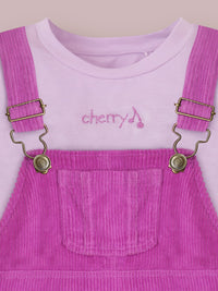 Brighten up your little girl’s summer wardrobe with the Cherry Crumble Lavender Dungaree Dress, a charming and comfortable outfit crafted for all-day wear.